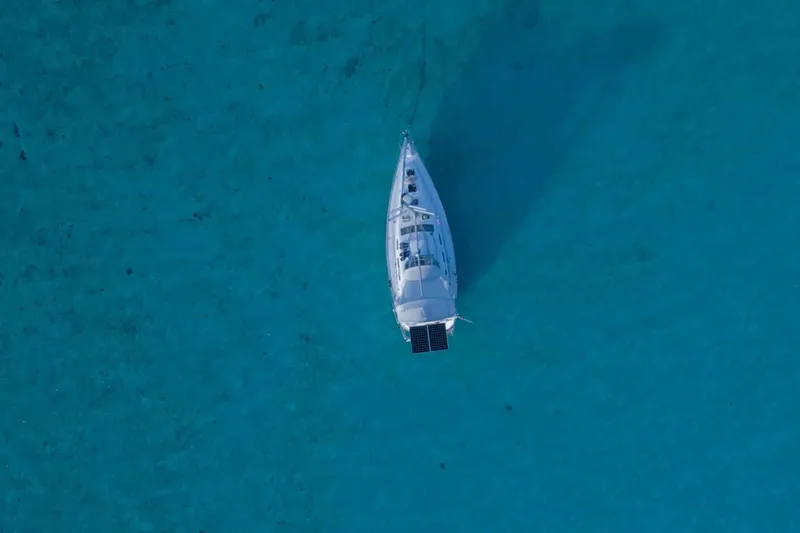 Monlove Yacht Photos Pics Aerial view of 2007 Beneteau 393 sailboat on clear turquoise water.