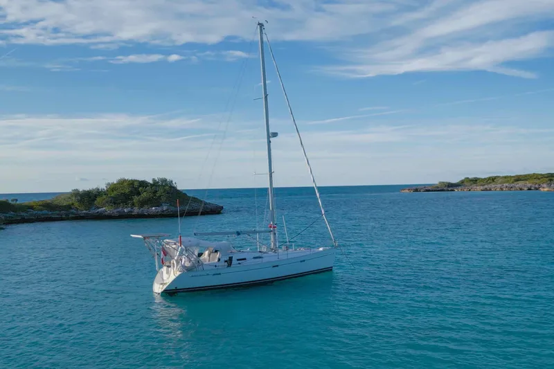 Monlove Yacht Photos Pics 2007 Beneteau 393 sailboat anchored in serene blue waters near lush islands.