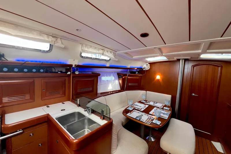 Monlove Yacht Photos Pics Luxurious interior of 2007 Beneteau 393 yacht with dining area and kitchenette.