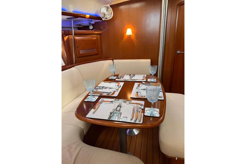 Monlove Yacht Photos Pics Elegant dining area in a 2007 Beneteau 393 yacht, featuring a set table and cozy seating.