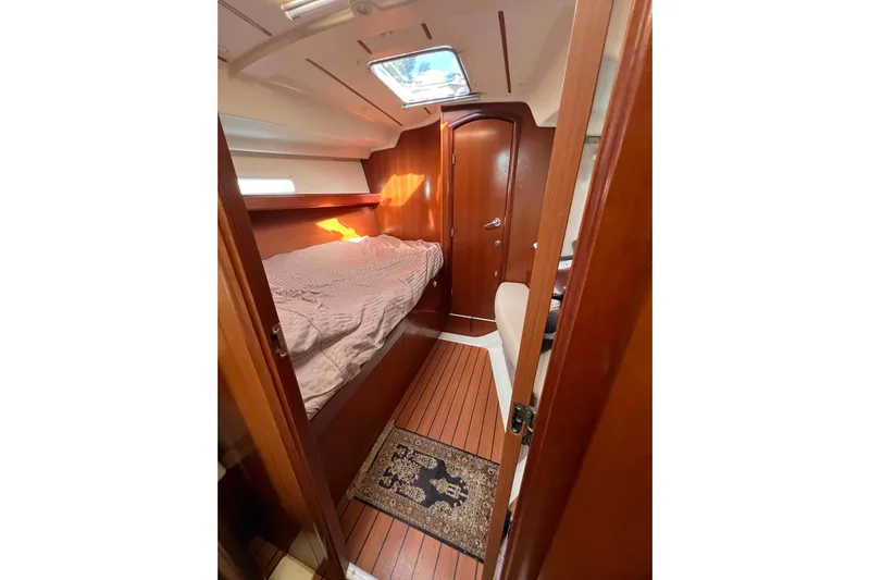 Monlove Yacht Photos Pics Cozy cabin interior of 2007 Beneteau 393 sailboat with wooden finish.