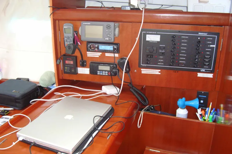 Monlove Yacht Photos Pics Navigation station on a 2007 Beneteau 393 yacht with electronics and laptop.