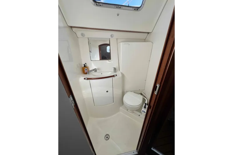 Monlove Yacht Photos Pics Beneteau 393 2007 yacht bathroom with sink, mirror, and toilet.