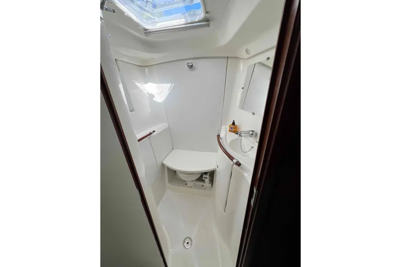 Monlove Yacht Photos Pics Beneteau 393 2007 yacht bathroom with skylight, compact design, and modern fixtures.