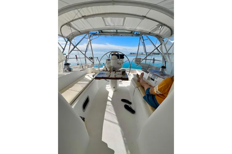 Monlove Yacht Photos Pics Interior view of a 2007 Beneteau 393 sailboat cockpit with a person relaxing.