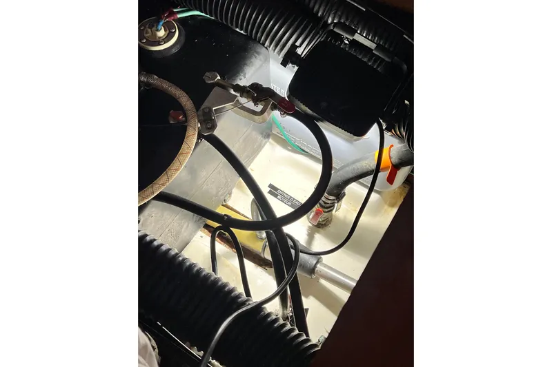 Monlove Yacht Photos Pics Engine compartment of a 2007 Beneteau 393 sailboat, showing hoses and wiring.