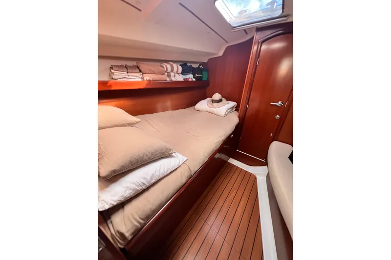 Monlove Yacht Photos Pics Cozy cabin interior of 2007 Beneteau 393 sailboat with wooden finish and comfortable bedding.