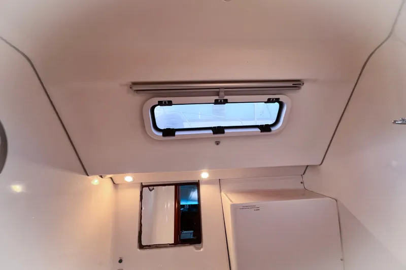Monlove Yacht Photos Pics Interior cabin view of a 2007 Beneteau 393 sailboat with ceiling hatch and lighting.