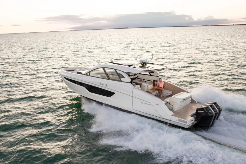  Yacht Photos Pics 2026 Cruisers Yachts 50 GLS cruising on open water at sunset.