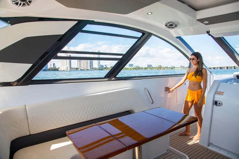  Yacht Photos Pics 2026 Cruisers Yachts 50 GLS interior with woman enjoying the view.