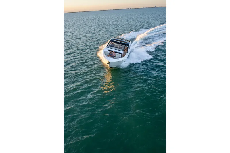  Yacht Photos Pics 2026 Cruisers Yachts 50 GLS cruising on open water at sunset.