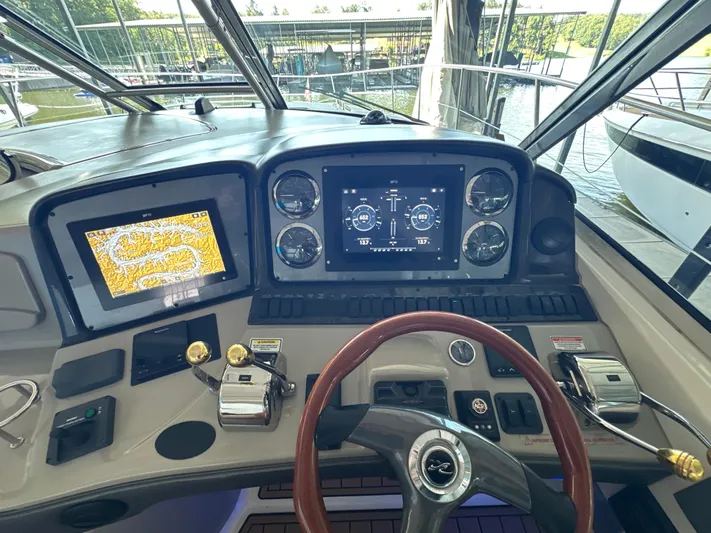  Yacht Photos Pics Helm of 2005 Sea Ray 420 Sundancer with navigation screens and controls.