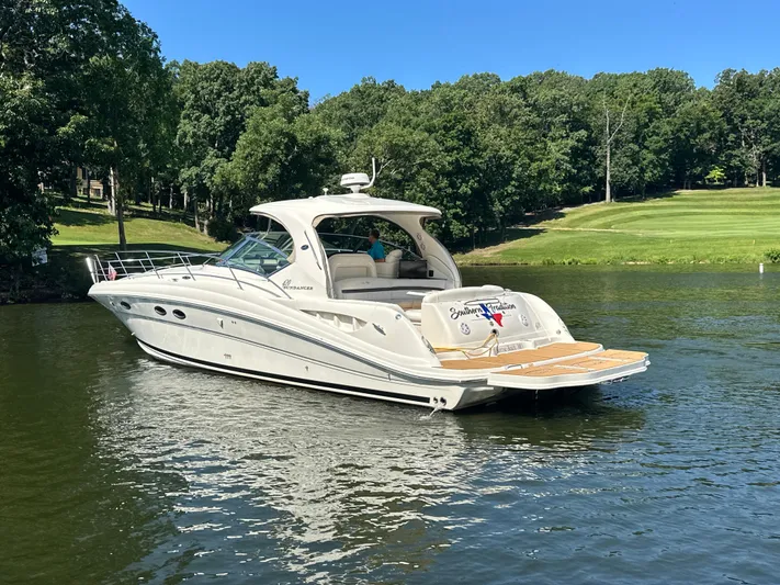  Yacht Photos Pics 2005 Sea Ray 420 Sundancer yacht on a serene lake with lush green surroundings.