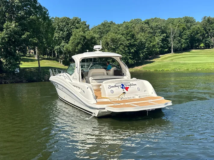  Yacht Photos Pics 2005 Sea Ray 420 Sundancer yacht on a serene lake with lush green surroundings.