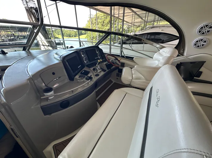  Yacht Photos Pics 2005 Sea Ray 420 Sundancer helm with leather seats and modern controls.