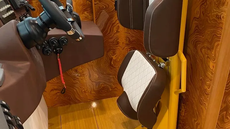 1676 Yacht Photos Pics Interior of a 2023 Custom RIB 60 boat with brown seats and wood paneling.