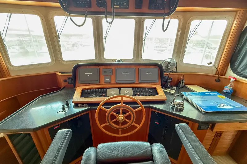 Ring Leader Yacht Photos Pics Pilot house of a 2007 Nordic Tug 54 with navigation equipment and steering wheel.