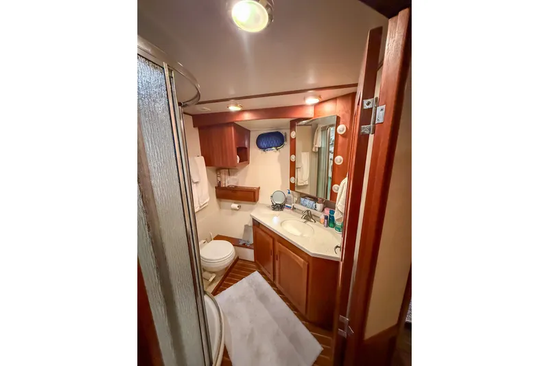 Ring Leader Yacht Photos Pics Luxurious bathroom in 2007 Nordic Tug 54 yacht with wood accents and modern amenities.