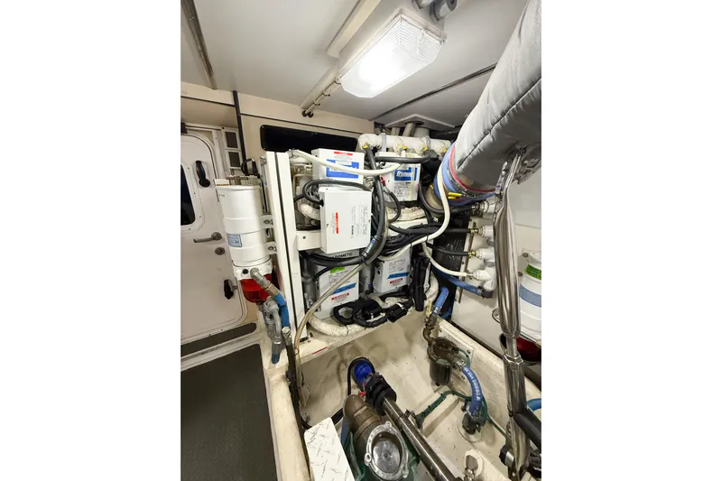 Ring Leader Yacht Photos Pics Engine room of 2007 Nordic Tug 54, showcasing complex machinery and piping.