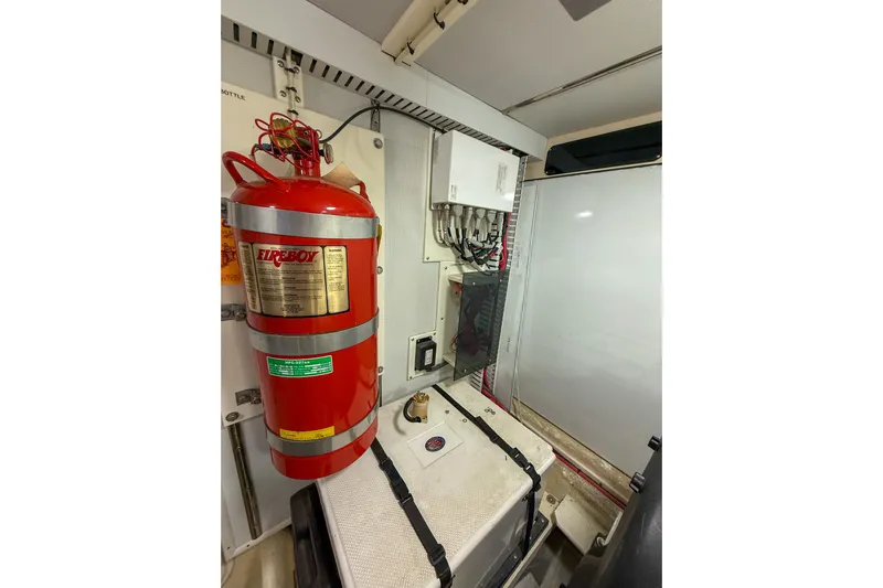 Ring Leader Yacht Photos Pics Engine room of 2007 Nordic Tug 54 with fire extinguisher and electrical panel.