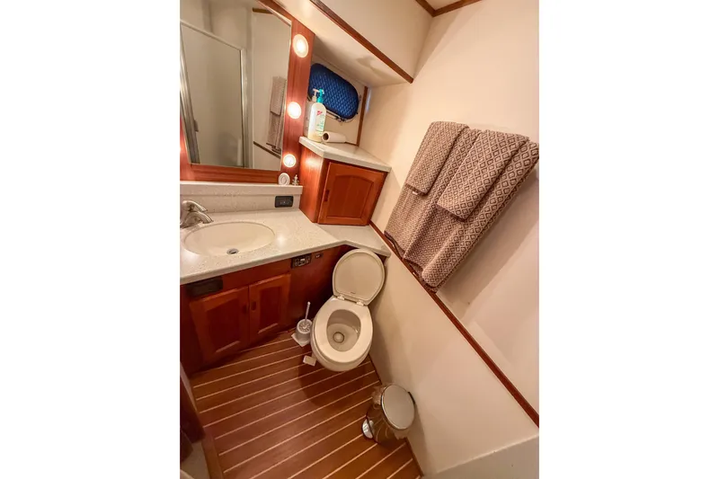Ring Leader Yacht Photos Pics Luxurious bathroom in 2007 Nordic Tug 54 yacht with wooden flooring and modern fixtures.