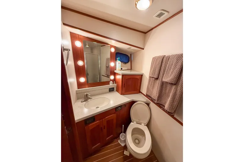 Ring Leader Yacht Photos Pics Luxurious bathroom in 2007 Nordic Tug 54 yacht with wood accents and modern fixtures.