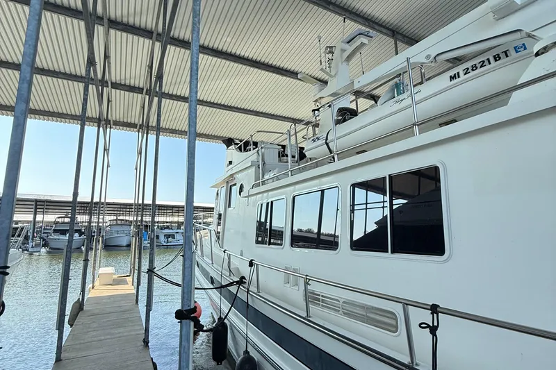 Ring Leader Yacht Photos Pics 2007 Nordic Tug 54 docked in a covered marina, side view.