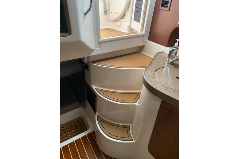  Yacht Photos Pics Interior of 2014 Grady-White Express 330 boat, featuring steps and a compact sink area.