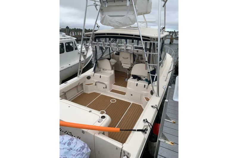  Yacht Photos Pics 2014 Grady-White Express 330 boat docked, featuring spacious deck and seating area.