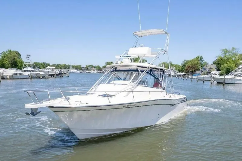  Yacht Photos Pics 2014 Grady-White Express 330 boat cruising on a sunny day in a marina.