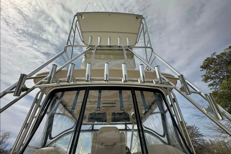  Yacht Photos Pics 2014 Grady-White Express 330 boat with tower against cloudy sky.
