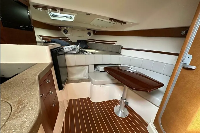  Yacht Photos Pics 2014 Grady-White Express 330 cabin interior with seating, table, and wood accents.