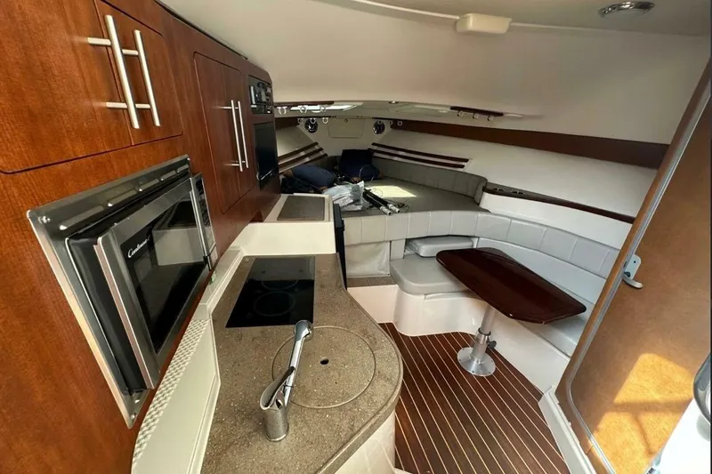  Yacht Photos Pics Interior of 2014 Grady-White Express 330 boat with kitchen and seating area.