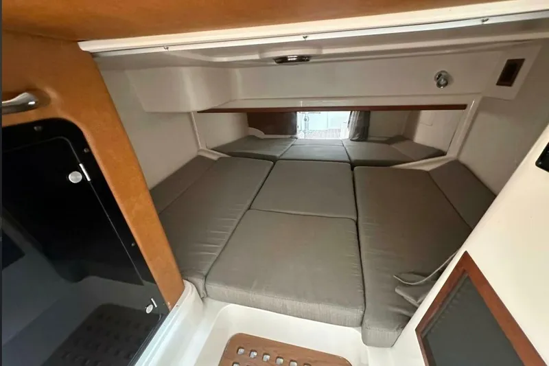  Yacht Photos Pics 2014 Grady-White Express 330 cabin interior with cushioned sleeping area.