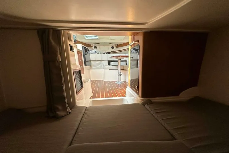  Yacht Photos Pics 2014 Grady-White Express 330 cabin interior with cozy sleeping area and wooden flooring.