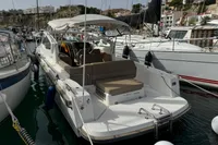 2022 Nimbus W9 boat docked in a marina, surrounded by other vessels.