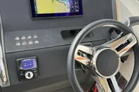 Steering console of a 2022 Nimbus W9 boat with navigation display and controls.
