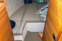 Cozy cabin interior of 2022 Nimbus W9 boat with cushions and wooden finish.