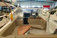 2022 Nimbus W9 boat interior with seating and steering in a showroom.