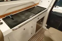 Interior of 2022 Nimbus W9 boat featuring a sleek kitchenette with modern appliances.