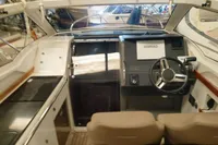 Interior of a 2022 Nimbus W9 boat featuring a modern helm and seating area.