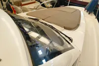2022 Nimbus W9 boat with cushioned deck, sleek design, and windshield wipers in a showroom.