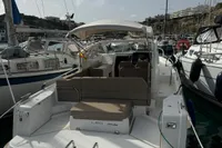 2022 Nimbus W9 boat docked in a marina, surrounded by other vessels.