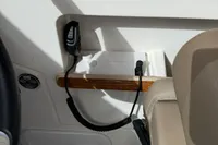 Interior of 2022 Nimbus W9 boat with wooden trim and communication device.