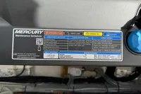 Mercury maintenance schedule label on Nimbus W9, 2022 model, detailing fluid checks and specifications.