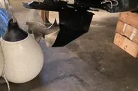 Propeller and rudder of 2022 Nimbus W9 boat in a garage setting.