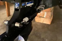 Close-up of a Nimbus W9 2022 boat propeller and motor in a garage setting.