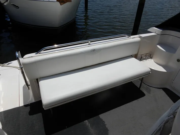  Yacht Photos Pics White seating area on 2006 Regal Commodore 3760 IO boat, docked by water.