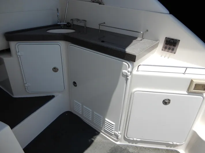  Yacht Photos Pics 2006 Regal Commodore 3760 IO boat kitchenette with sink and storage cabinets.