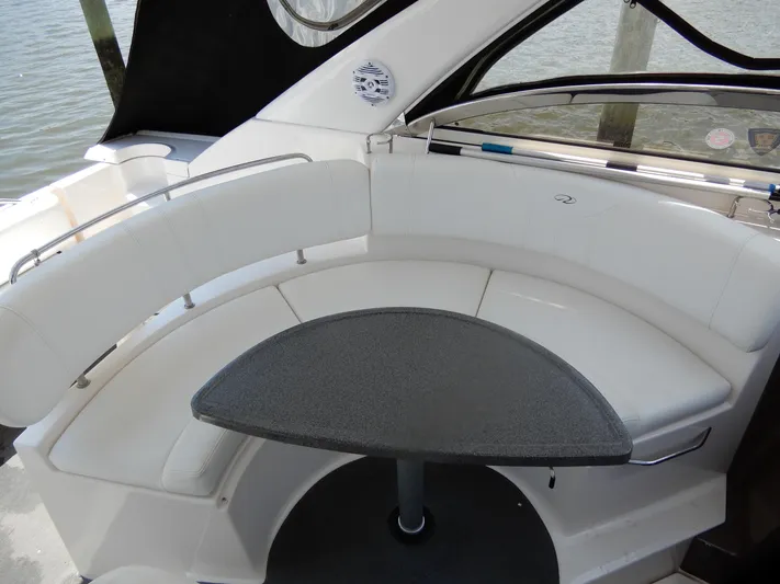  Yacht Photos Pics 2006 Regal Commodore 3760 IO boat interior with white seating and a small table.